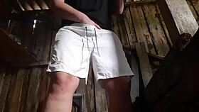 village brunette sneaks to the barn for solo play, keeping clothes on to avoid getting caught.