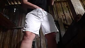 village brunette sneaks to the barn for solo play, keeping clothes on to avoid getting caught.