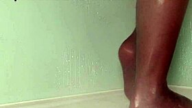 Teasing nylon feet in the wet shower, stockings on toes.
