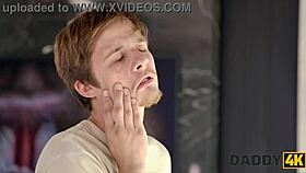 Man, this slutty gf is sucking cock and stripteasing for another right in the same room!