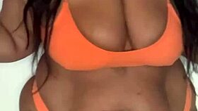 This ebony milf in a bikini dances, shaking her big tits and ass