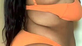 This ebony milf in a bikini dances, shaking her big tits and ass