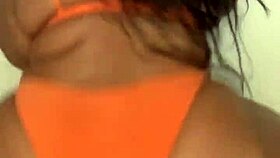 This ebony milf in a bikini dances, shaking her big tits and ass
