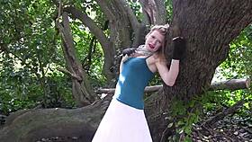 The wife masturbates her shaved pussy on a tree