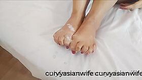 Asian Slutwife Gives Footjob And Takes Cum On Feet