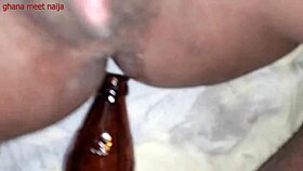 An ebony Ghana girl with onion booty fucks a malt bottle