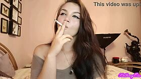 Xo bunny, the brunette Latina with blue eyes, smokes and blows smoke in your face