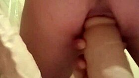 Engaging in detailed self-pleasuring activities with extreme toys and dildos.