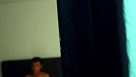 A young Colombian person is masturbating solo on vacation with his tattoos showing in the room quietly