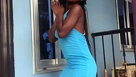 A crazy woman twerks wildly on the balcony under the open sky