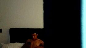 A young Colombian person is masturbating solo on vacation with his tattoos showing in the room quietly