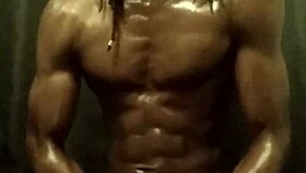 He's stroking his big black cock with loads of oil