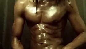 He's stroking his big black cock with loads of oil