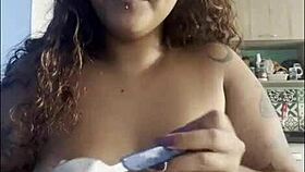 Curvy woman drinks coffee naked while chatting with the camera.