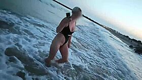 Blonde shows tits and sucks cock on a public beach