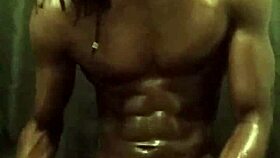 He's stroking his big black cock with loads of oil