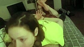 Laying on her stomach and deepthroating the slave's cock