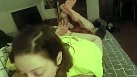 Laying on her stomach and deepthroating the slave's cock