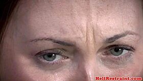 The tattooed participant endures a domination session with clamps.