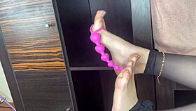 closeup foot in black stockings teases anal bed play