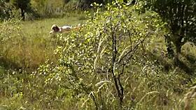 on this wild beach, does the naked blonde notice the pervert jerking off?