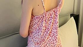 Young woman models flower print camisole, showcasing slender figure and small waist