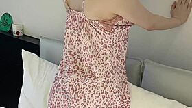 Young woman models flower print camisole, showcasing slender figure and small waist