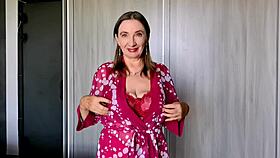 That granny in red lingerie and stockings teases with huge tits and dirty talk