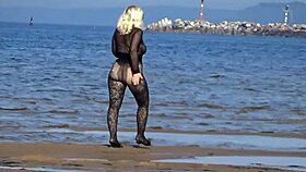 Beautiful milf in black style flashes big tits and ass on the beach