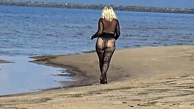 Beautiful milf in black style flashes big tits and ass on the beach