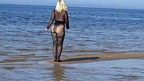 Beautiful milf in black style flashes big tits and ass on the beach