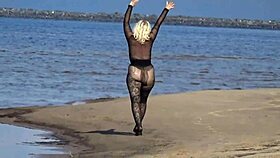 Beautiful milf in black style flashes big tits and ass on the beach