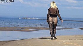 Beautiful milf in black style flashes big tits and ass on the beach