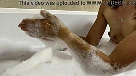 brunette milf sings naked in the bath, revealing hairy pussy