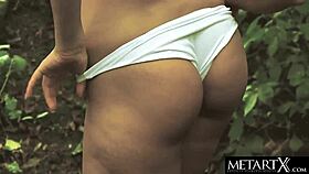 sexy green-eyed beauty with perfect breasts masturbates outdoors in the forest.