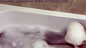 brunette milf sings naked in the bath, revealing hairy pussy
