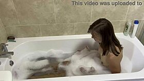brunette milf sings naked in the bath, revealing hairy pussy