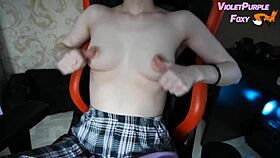 young woman plays with her nipples when she is home alone