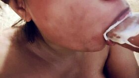 sucking on a big realistic and messy full of milk dildo closeup