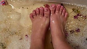 barefoot beauty washes feet with rose petals after long day