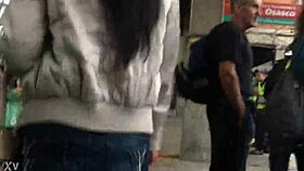 woman in jacket and boots rides train candidly