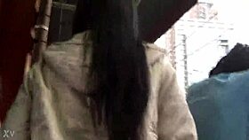 woman in jacket and boots rides train candidly