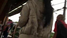 woman in jacket and boots rides train candidly