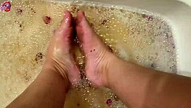 barefoot beauty washes feet with rose petals after long day