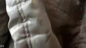 woman in jacket and boots rides train candidly