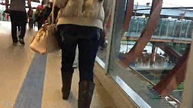 woman in jacket and boots rides train candidly