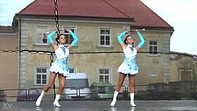 two charming majorettes showcase their energetic cheer skills