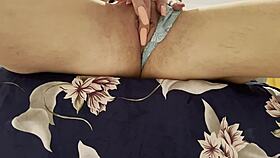 a woman rubs her sensitive spot to an explosive climax in close-up view on bed