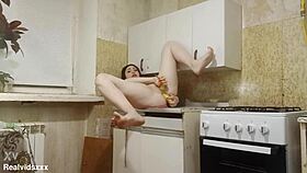 Shaved brunette stuffs bananas double in kitchen solo?