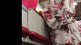 granny browses store shelves in flowing skirt spied from below